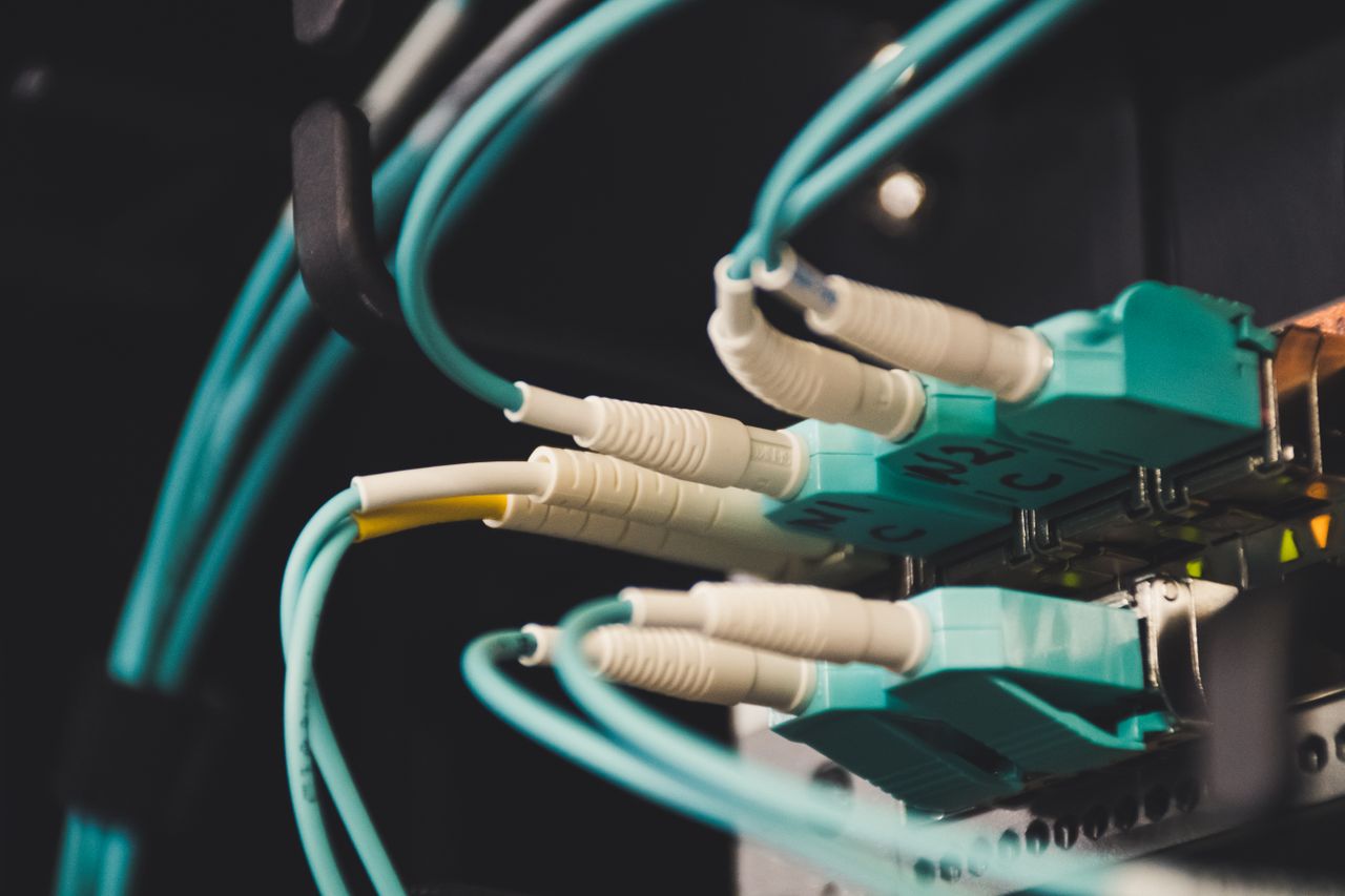 Mastering the First Impression: Your intriguing post title goes here Detailed view of fiber optic cables and ports in a server room, showcasing connectivity.