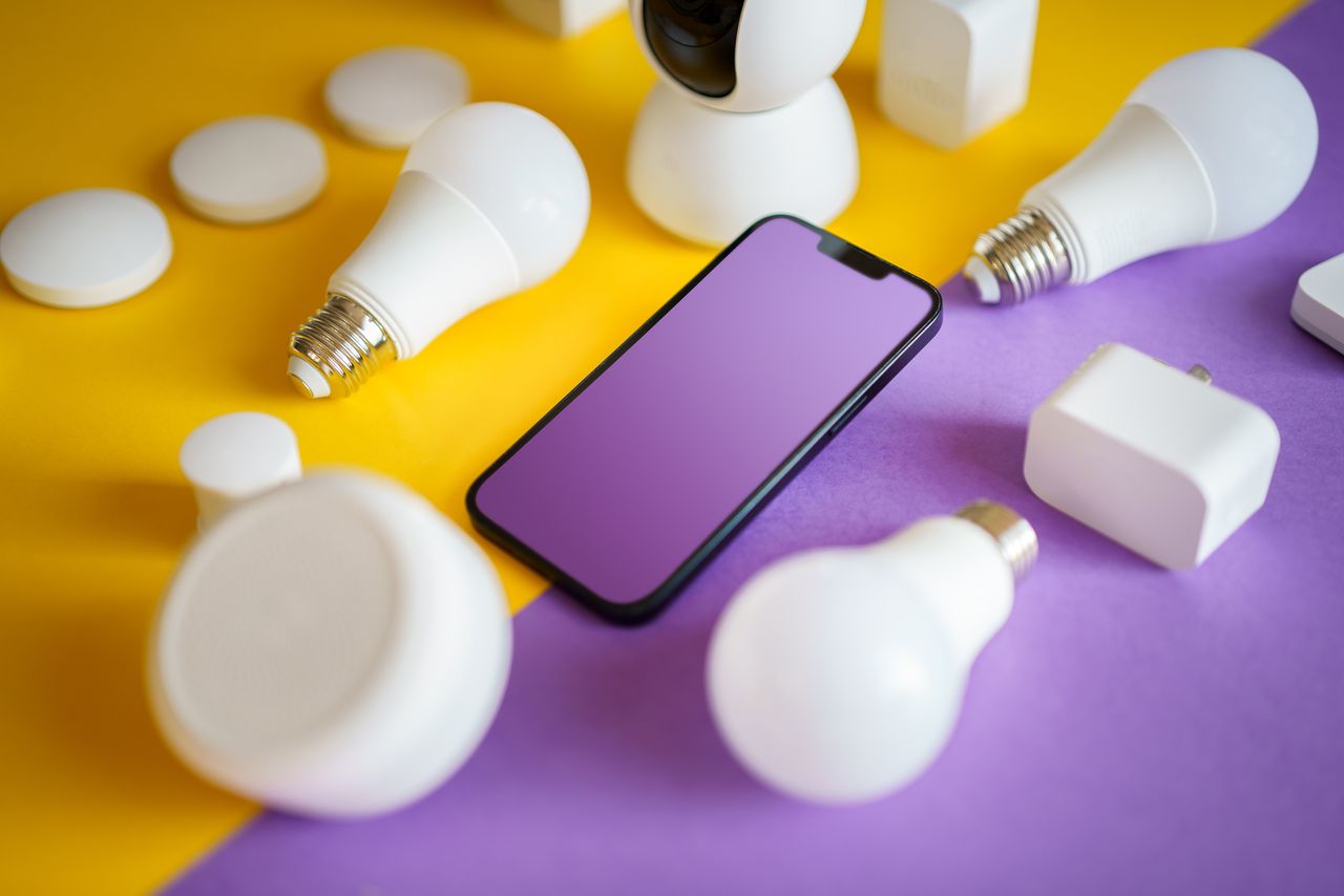 Contact Colorful flat lay of smart home devices and smartphone on vibrant background, ideal for technology concepts.