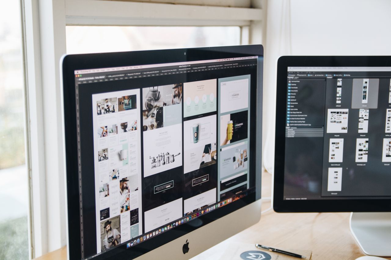 The Art of Drawing Readers In: Your attractive post title goes here Modern office desk setup with dual monitors displaying design software, ideal for tech and business themes.